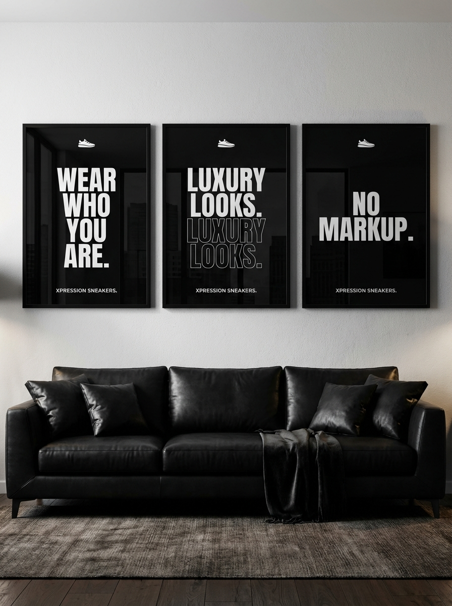 Black leather sofa with three framed posters on a wall.